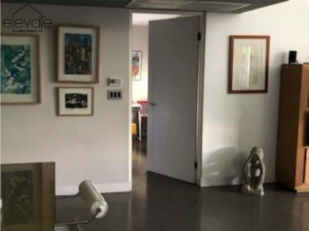 Minimalist bedroom with neutral decor and large window PH Portanova El Cangrejo Panama