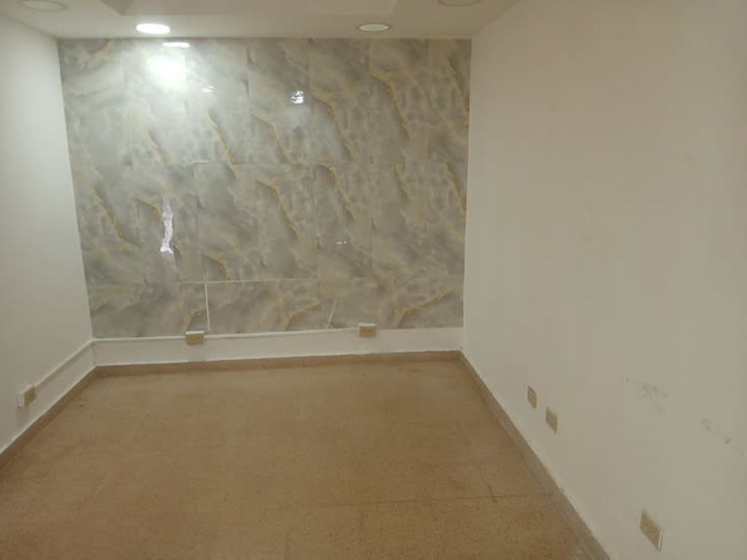 Modern unfurnished commercial office with marble accent wall and recessed lighting PH Panama Business Center Obarrio Panama