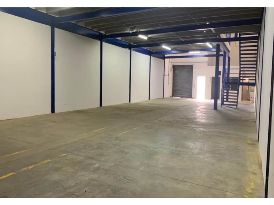 Inside view of warehouse rental in Panama City with mezzanine level, concrete floor and metal staircase