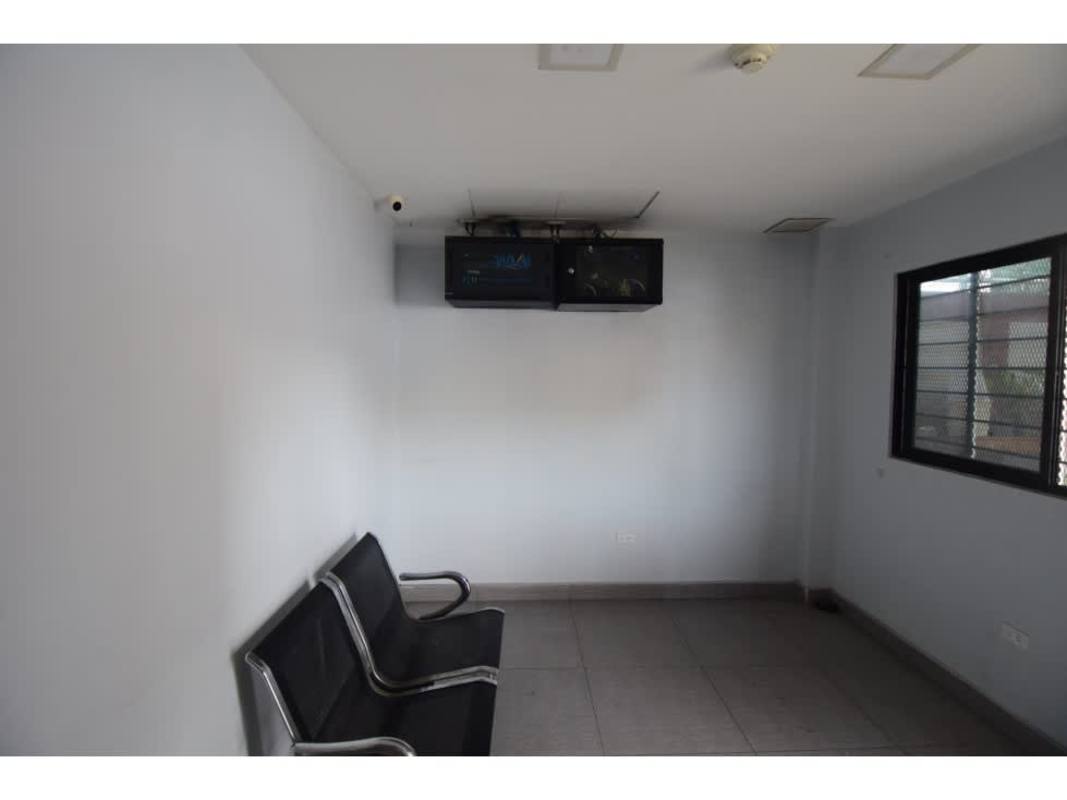 Large conference room with textured wall, wood table, and multiple chairs inside commercial galera Panama