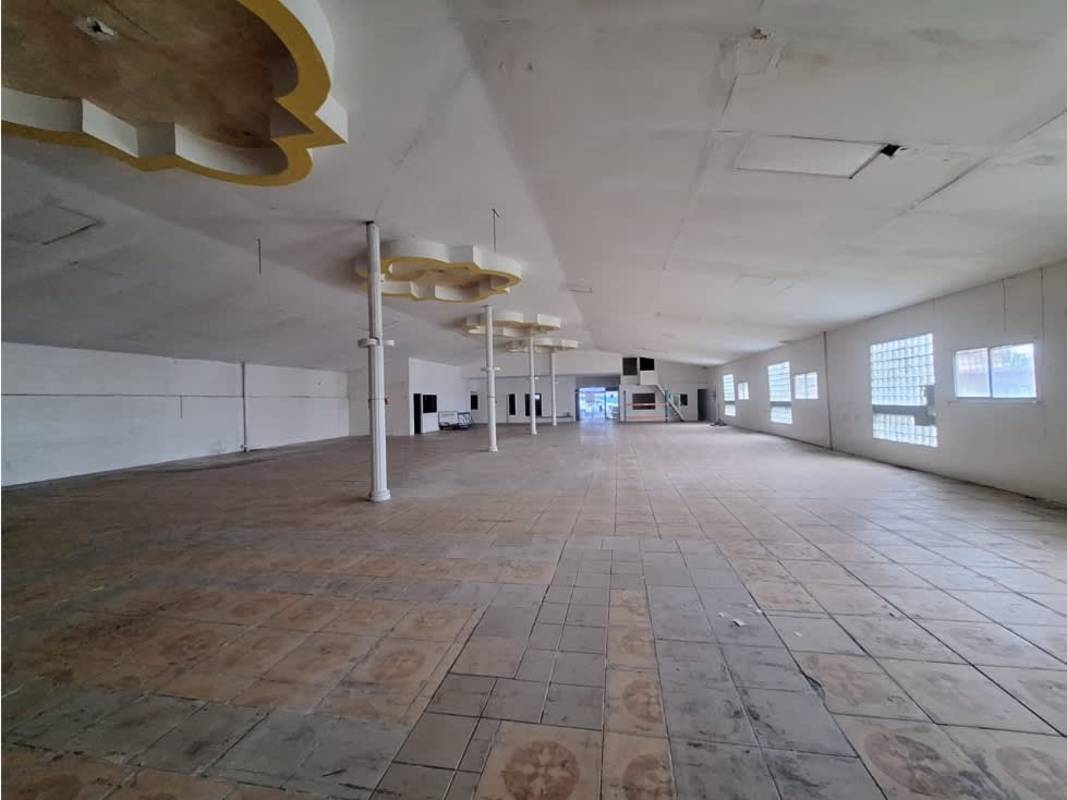 Large open interior space with tiled floors and decorative columns inside warehouse Panama City Rio Abajo