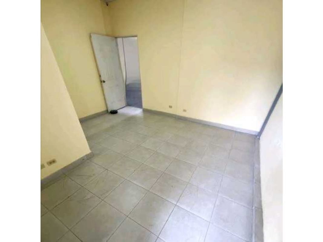 Vacant interior room with tiled floor, plain walls, and open door in warehouse complex Panama