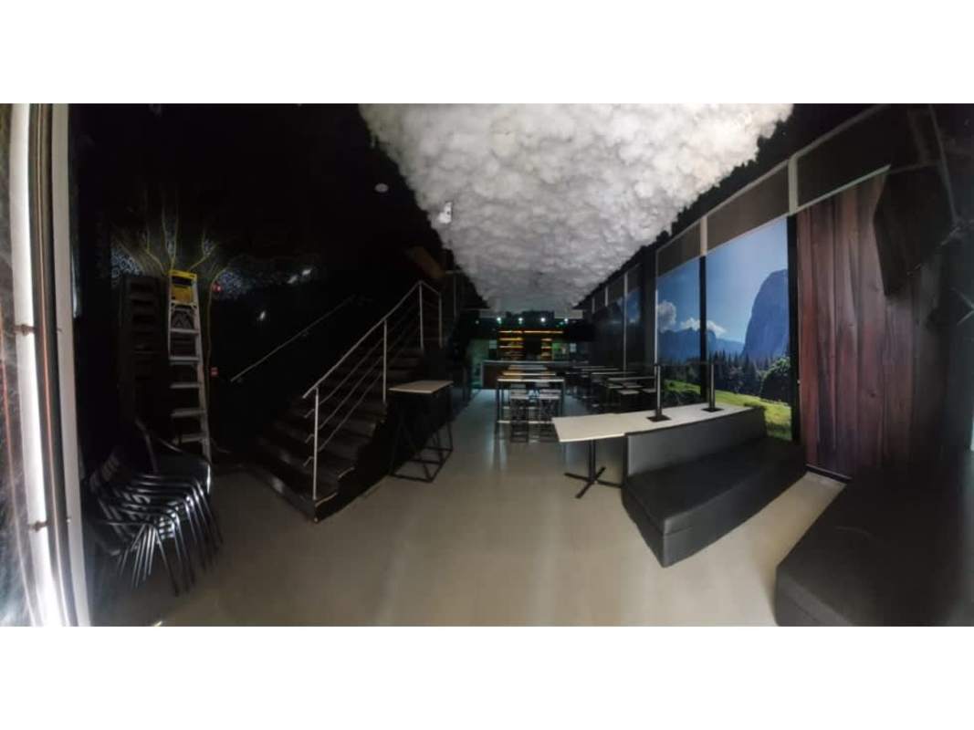 Restaurant interior in Plaza Triumph with mural art, cloud ceiling, black seating in Calle Uruguay Panama