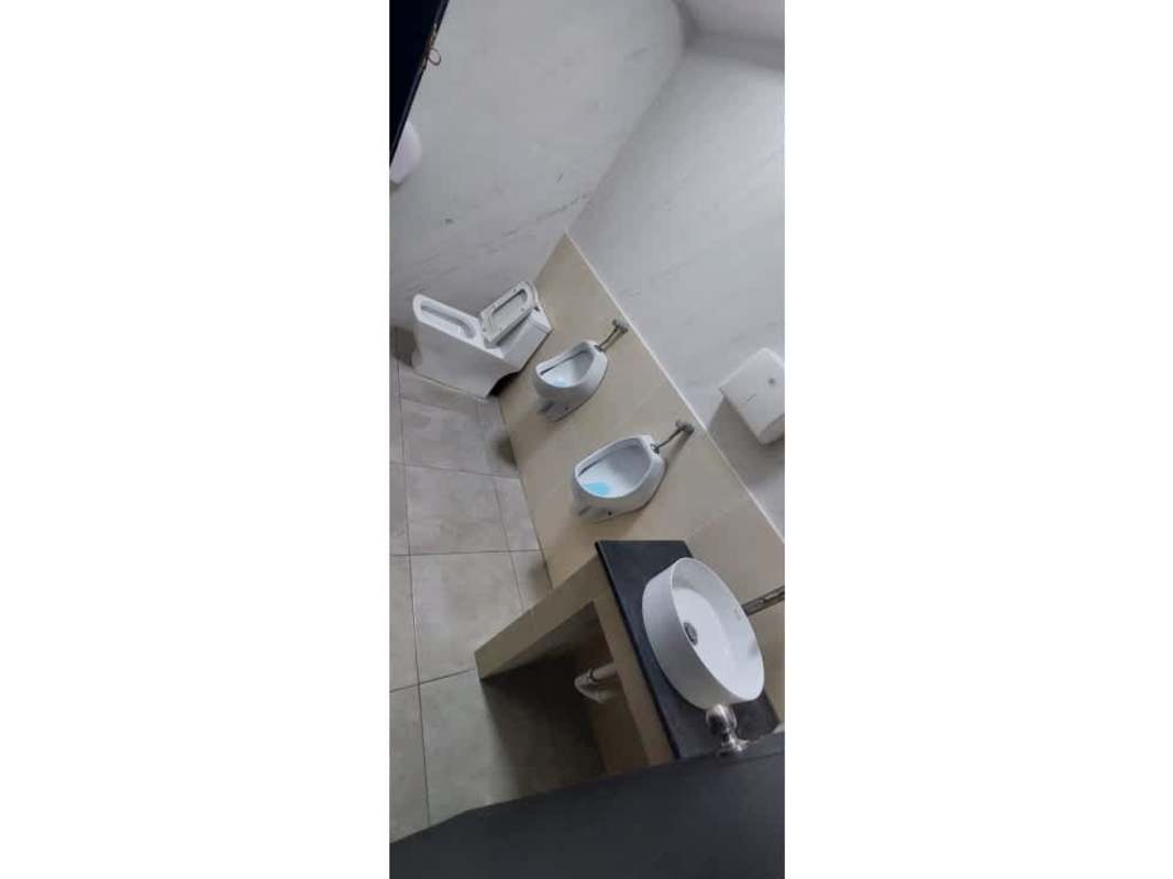 Public restroom with two urinals, toilet, tiled floors located in Plaza Triumph Calle Uruguay Bella Vista Panama