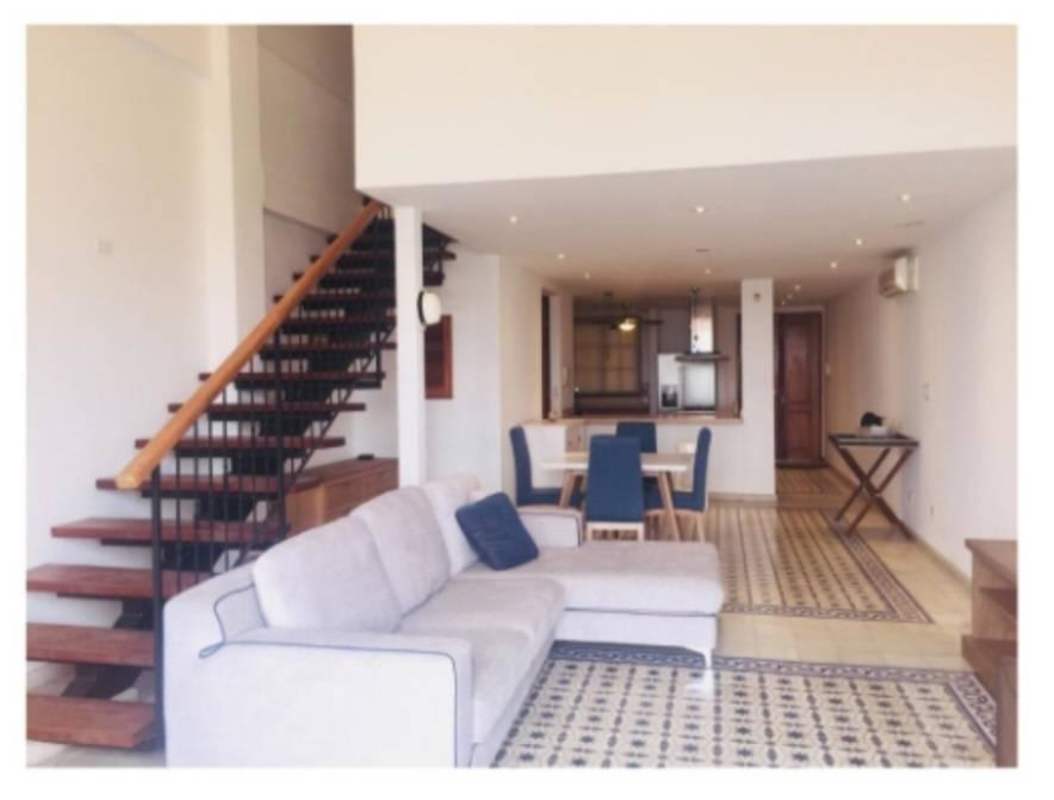 Open plan modern kitchen with wood accent staircase PH Casa Malecón Casco Viejo Panama