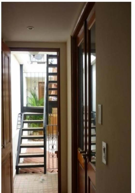 Contemporary hall with metal staircase and glass door PH Casa Malecón Casco Viejo