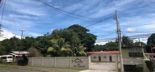 Traditional bathroom with glass shower, tiled walls, toilet and sink in rental apartment David Panama