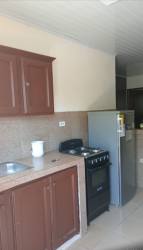 Traditional kitchen with granite countertop, brown cabinets, gas stove in rental apartment San Pablo Viejo David