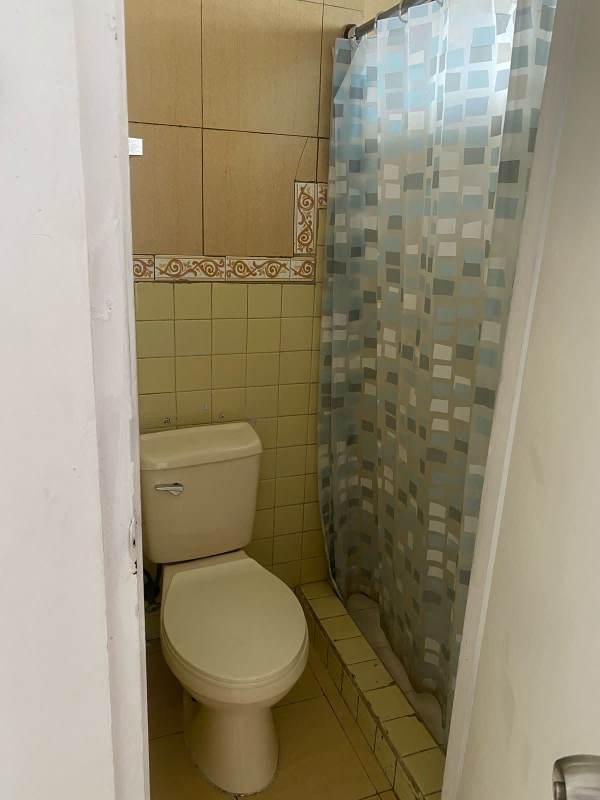 Single minimalist bedroom with window security bars and tiled floor PH Vía Israel near Multiplaza Panama