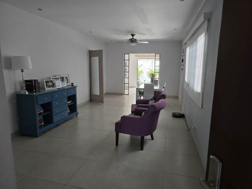 Indoor bar and entertainment space with wicker stools and tile floor in house for sale Chanis Panama