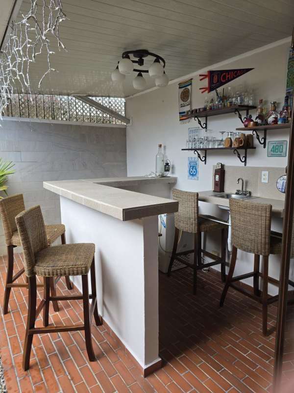 Open plan kitchen with granite countertops, patterned floor tiles, stainless appliances in house Panama