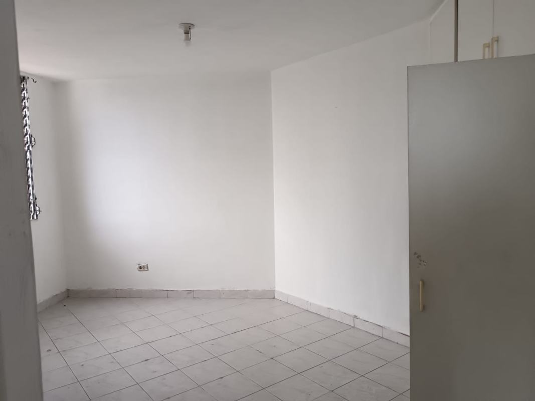 Bathroom featuring checkered shower curtain, tile walls, shelves PH Vista Hermosa Panama