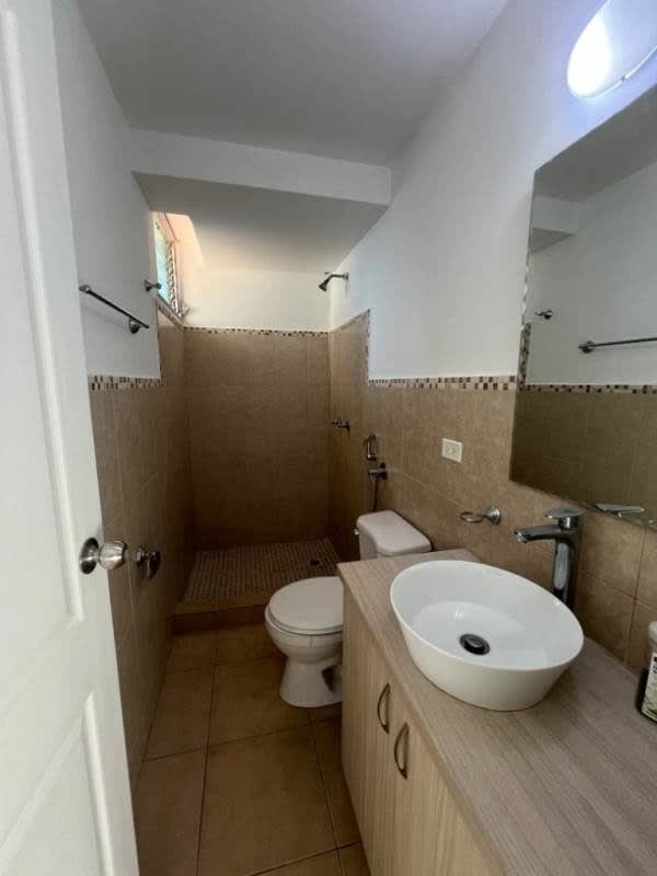Bathroom with shower, vessel sink, mirror and tiles in Carrasquilla Park Panama