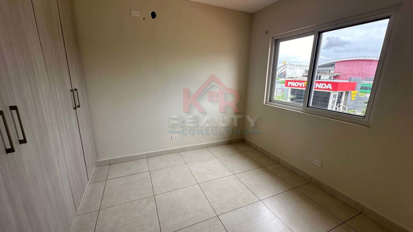 Bedroom with light wood closet and tile floor in Reserva de Versalles
