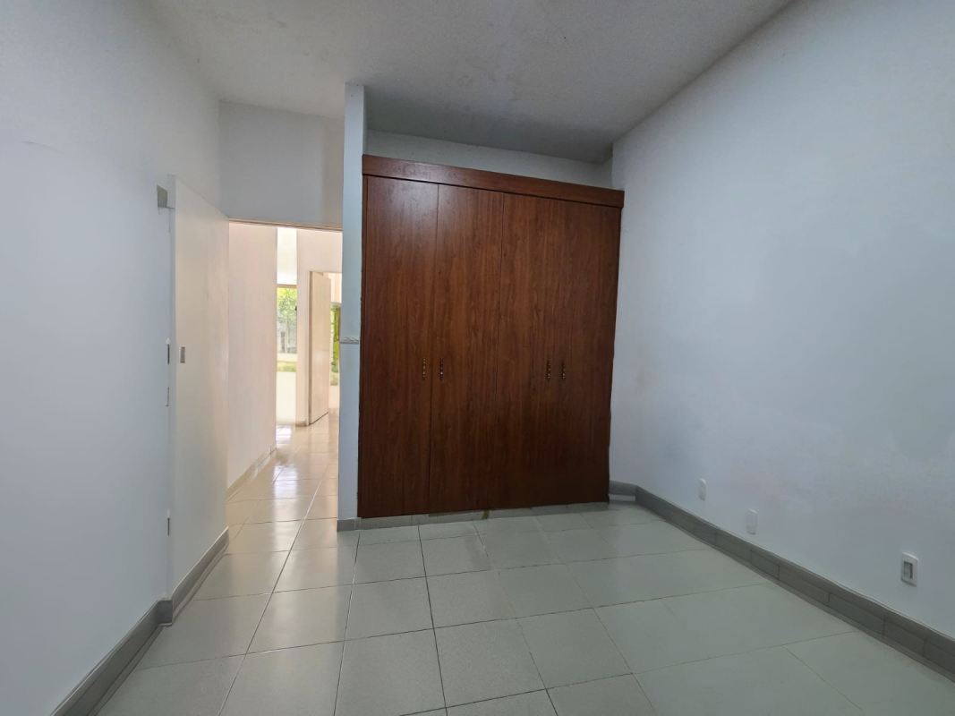 Minimalist bedroom with tiled floors, wardrobe, window at PH Parque Miraflores Panama City
