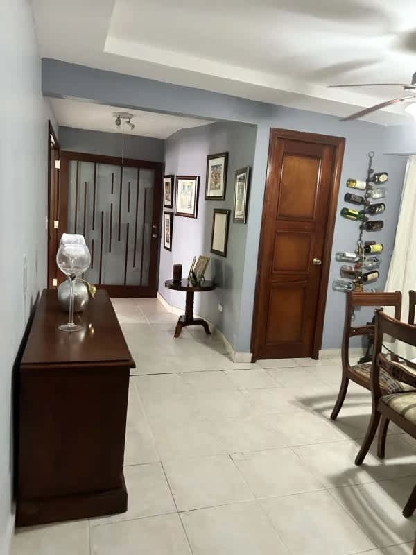 Dining room with ceiling fan adjacent to living space in house Condado del Rey Panama