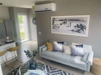 Elegant living room open plan kitchen bar counter modern decor The Tides beach house Panama