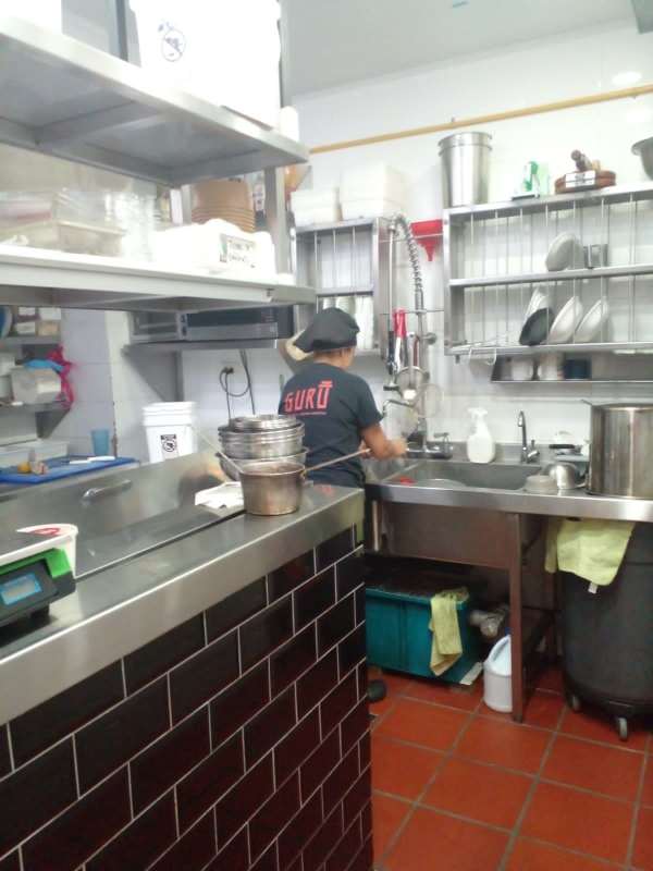 Fully equipped commercial kitchen area with stainless appliances and industrial sink in Plaza 74