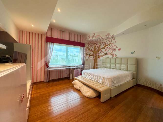 Elegant master bedroom with wood floors balcony access and garden views in Costa Las Perlas Panama