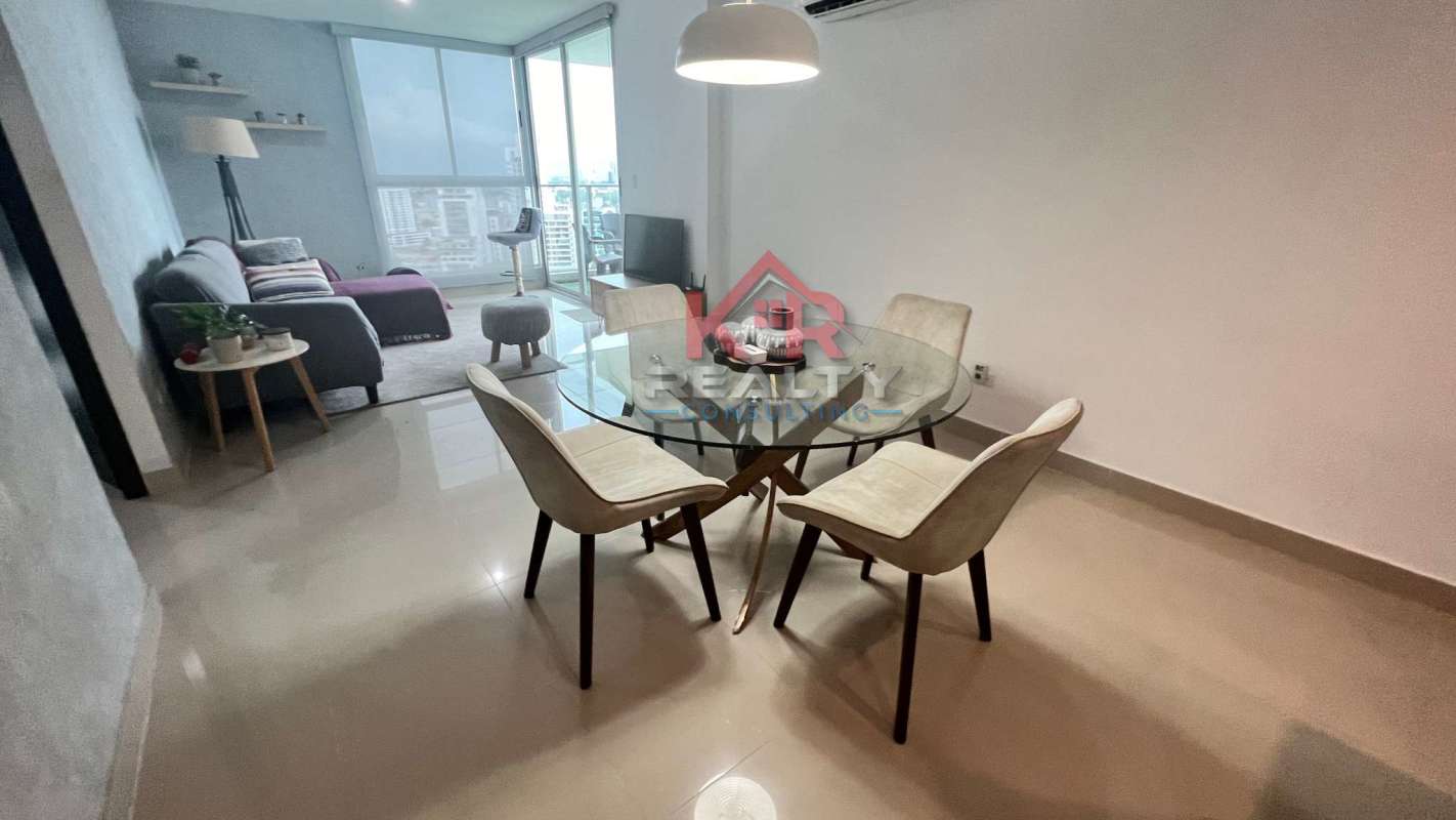 Modern kitchen with granite countertop, breakfast bar, wooden cabinets at Residencias del Sol Panama City