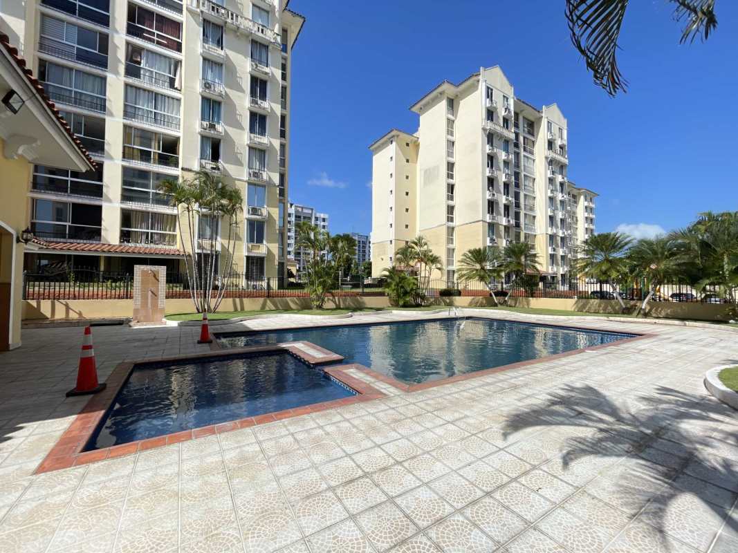 Outdoor pool complex with palm trees playground and seating Condado del Rey Panama