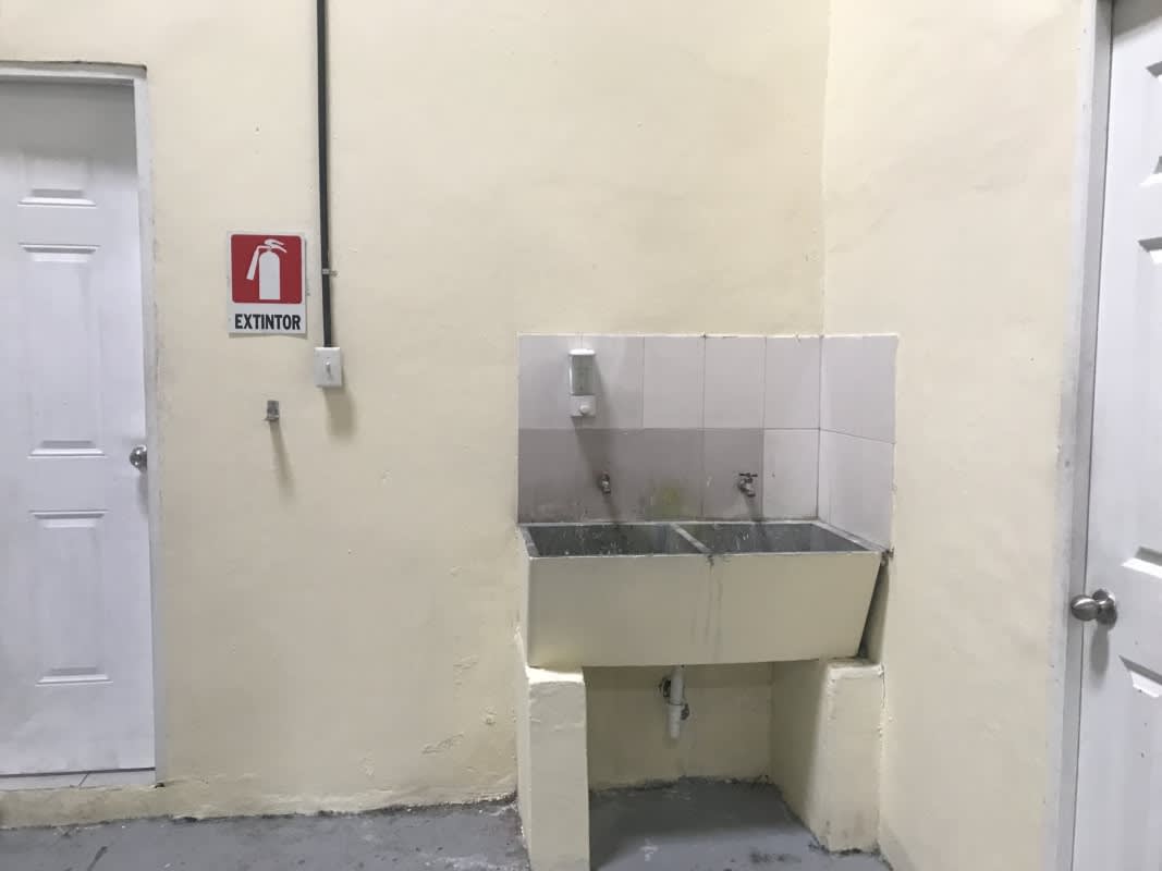 Utility wash area with double sink inside warehouse in Parque Lefevre Panama