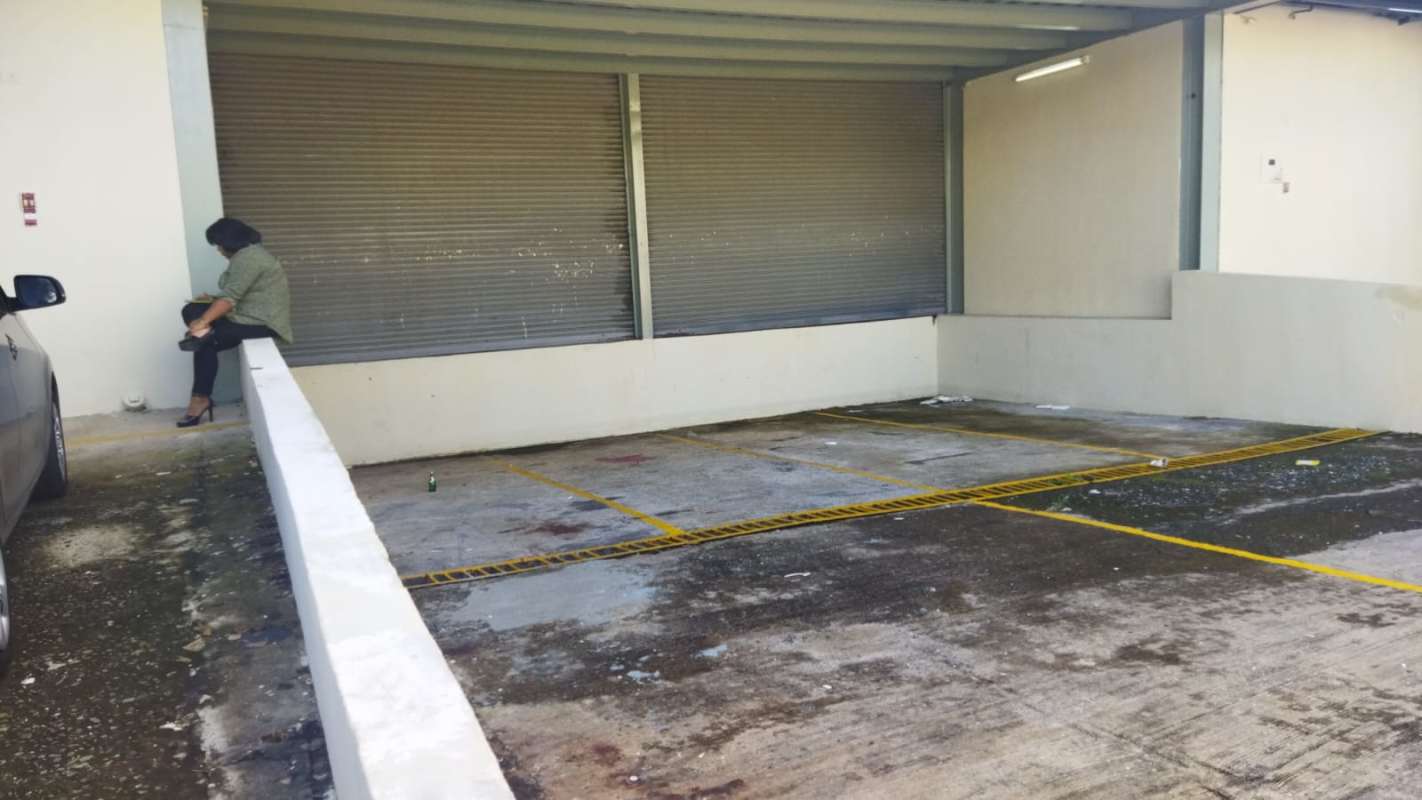 Parking area with roller shutters and marked bays in warehouse complex Parque Lefevre