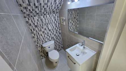 Sunny bedroom with closet, split AC, window, tile floors in PH Versalles Montelimar