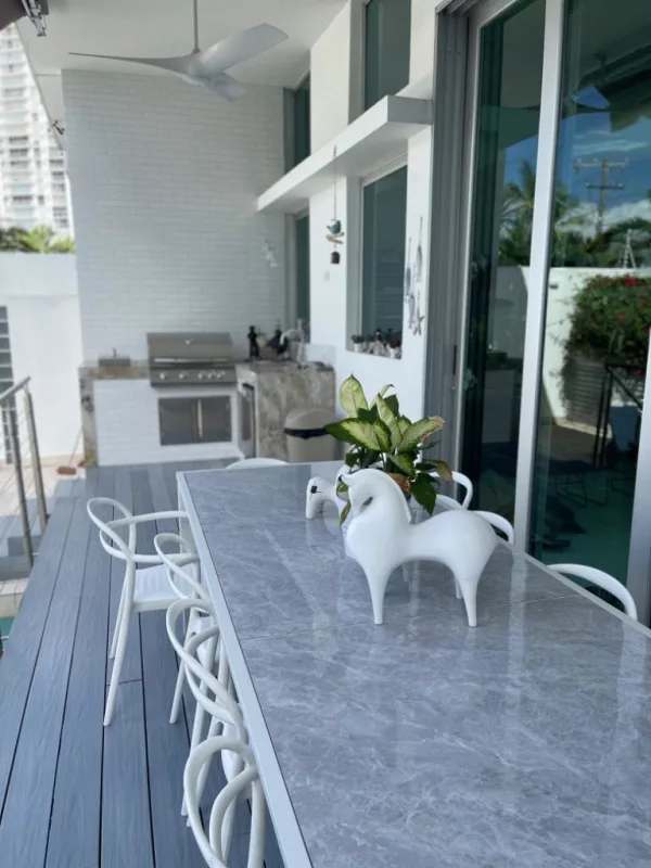 Modern outdoor terrace with dining set, BBQ grill, ceiling fan in Altos del Golf Panama City