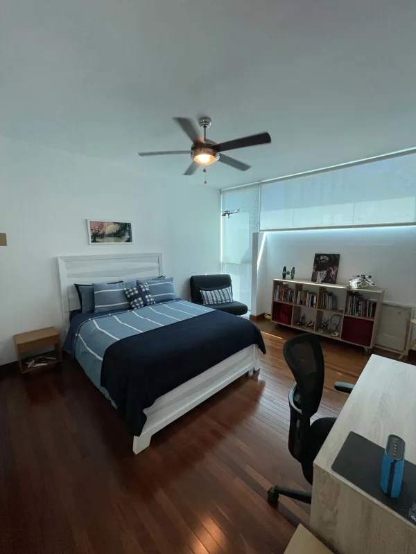 Modern bedroom with wood floors, large windows, desk workspace Altos del Golf Panama