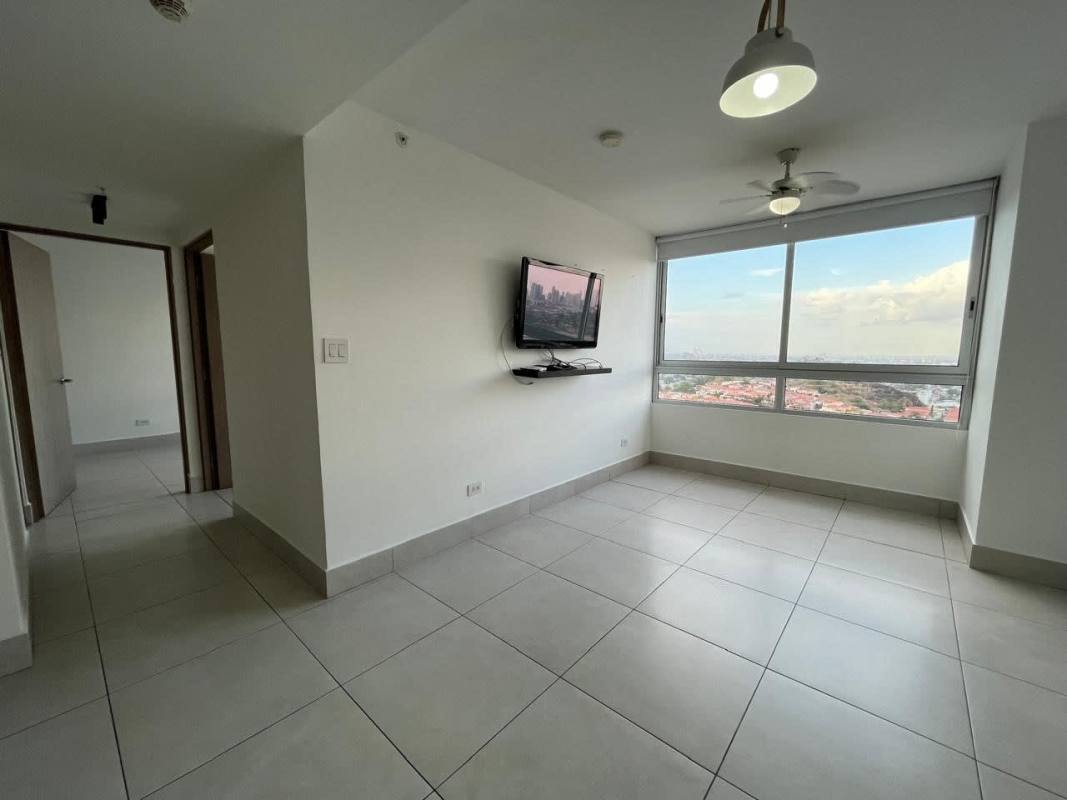 Living room with city view, wall-mounted TV spot, ceiling fan at PH Greenwood Panama City
