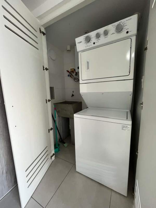 Compact laundry with utility sink and washer/dryer hookups at PH Greenwood Panama City