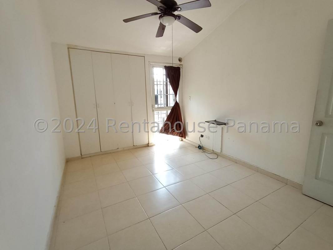 Bedroom with built-in closet window security bars ceiling fan in townhouse PH Villas del Naranjal Pedregal Panama