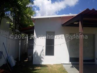 Large community pool inside Residencial Playa San Carlos with deck chairs