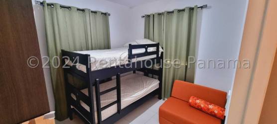 Single-family beach house side entrance in gated San Carlos community