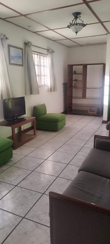 Traditional kitchen with cabinets, stove, fridge, tiled counters in furnished apartment for rent Panama Coco del Mar