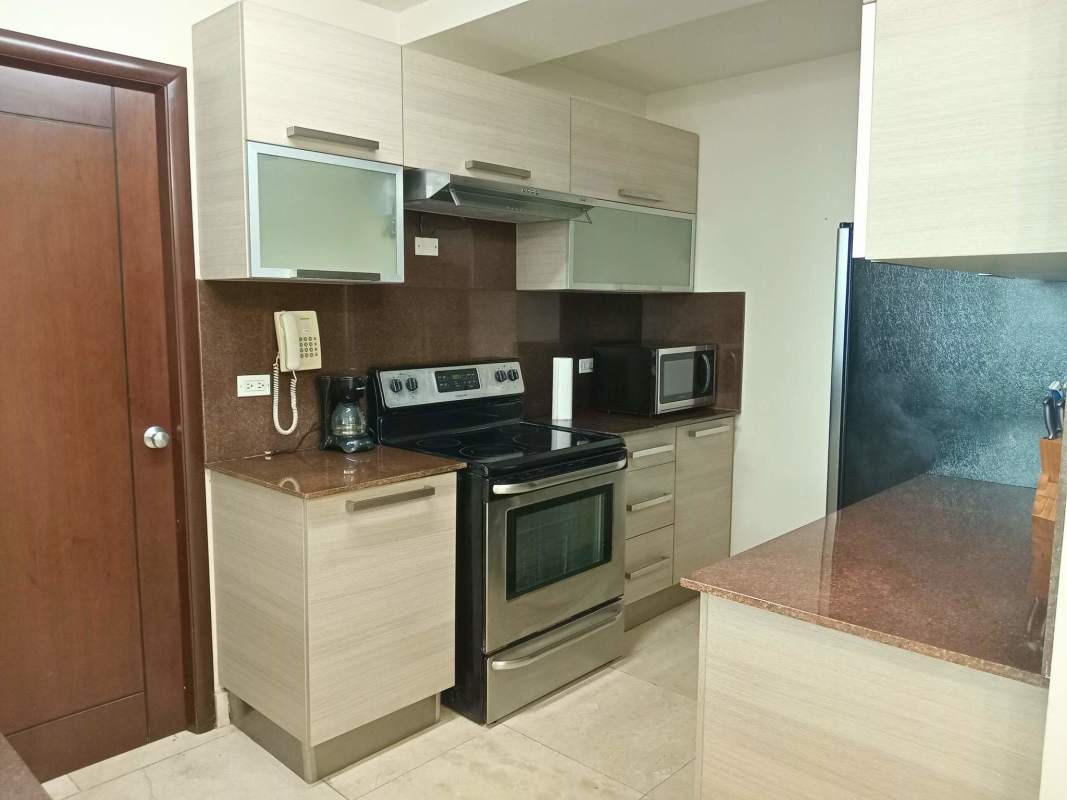 Bedroom with large window and city skyline view in PH Villa del Mar Avenida Balboa Panama