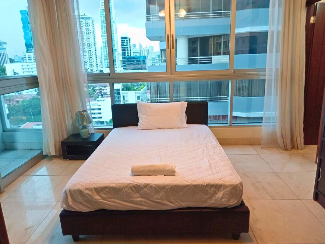 Modern bathroom with glass-enclosed shower and marble vanity in PH Villa del Mar Panama City