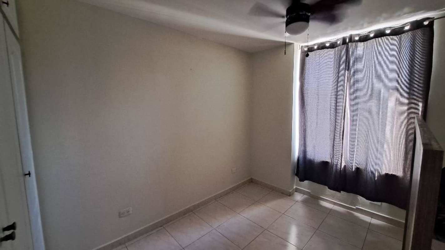 Empty bedroom featuring ceiling fan and tile floor with curtains PH Mc Gregor Valley Clayton Panama