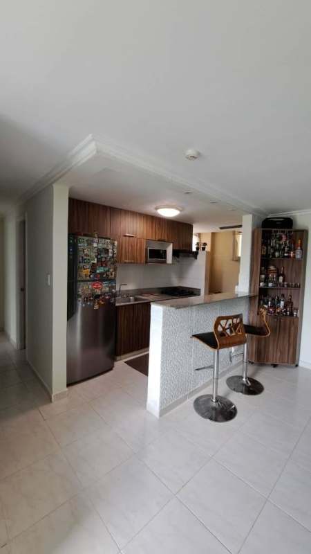 Modern kitchen with wood cabinets, appliances, breakfast bar in PH Mc Gregor Valley Clayton Panama