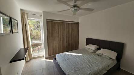Bedroom with large window, closet space, tile flooring in Coronado Garden Villas rental Panama