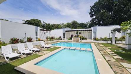 Modern bright living room with sliding doors to terrace in Coronado rental home Panama