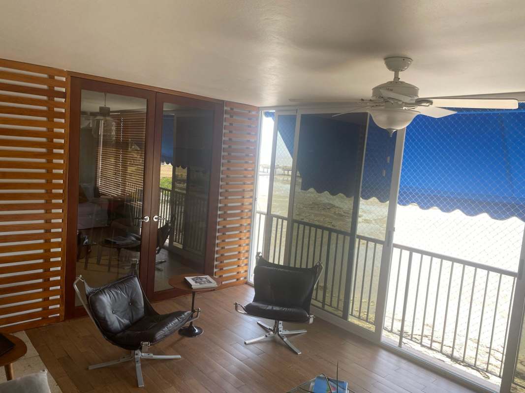 Balcony with safety mesh, wicker furniture and skyline view in Coco del Mar Panama