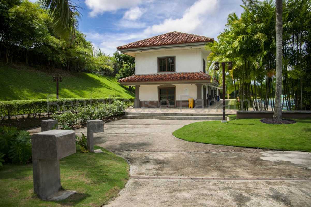 Two-story Mediterranean home with stucco walls, red tile roof, tropical landscaping Villa Zaita Panama