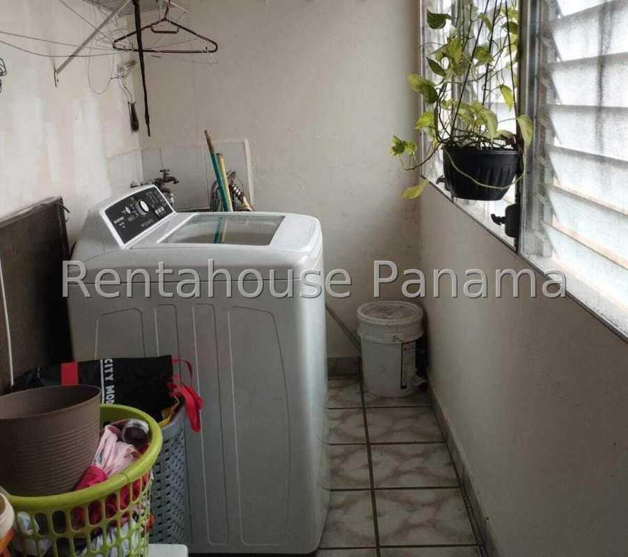 Laundry room with washing machine, window, storage space in Parque Lefevre Panama apartment