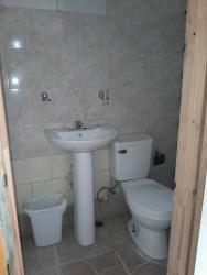 Simple room with two beds, tile flooring, colorful walls Chitré rental Herrera Panama