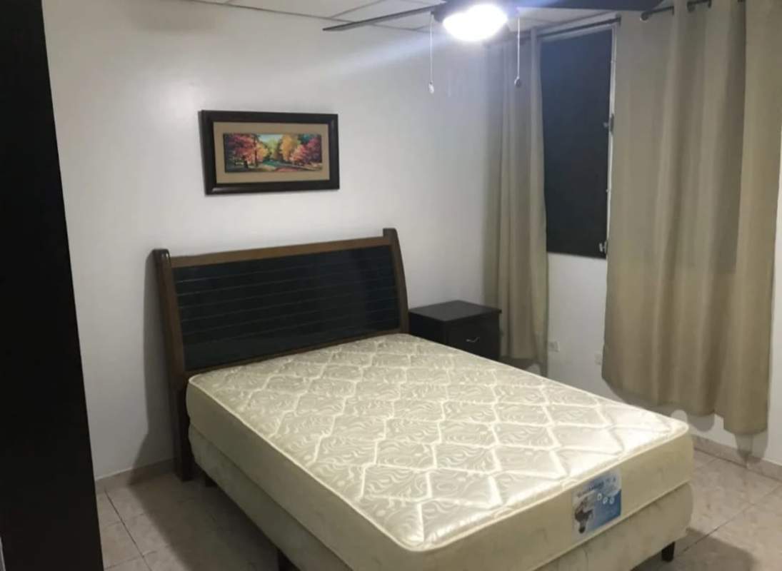 Kitchen view with cabinets, gas stove, microwave, range hood Betania Panama