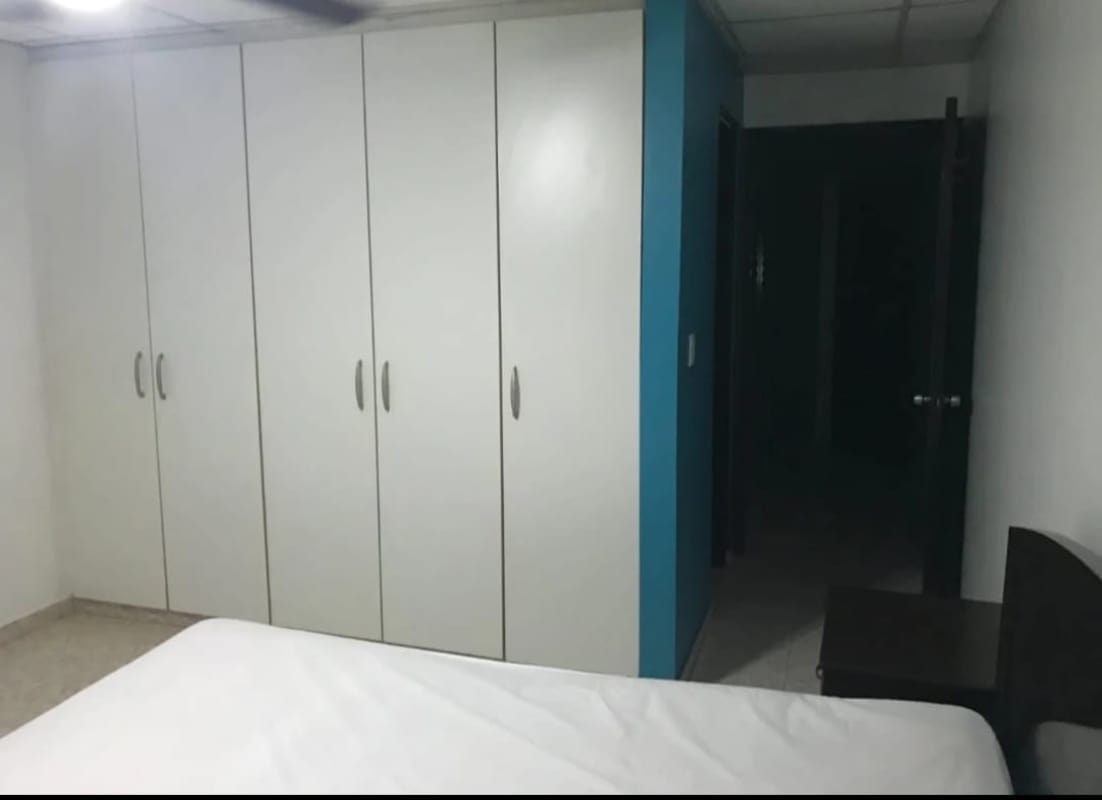 Bedroom with ceiling fan, large windows, tiled floor in Betania Panama City apartment