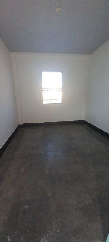 Simple room with cement floor and small window in central Panama City Calidonia