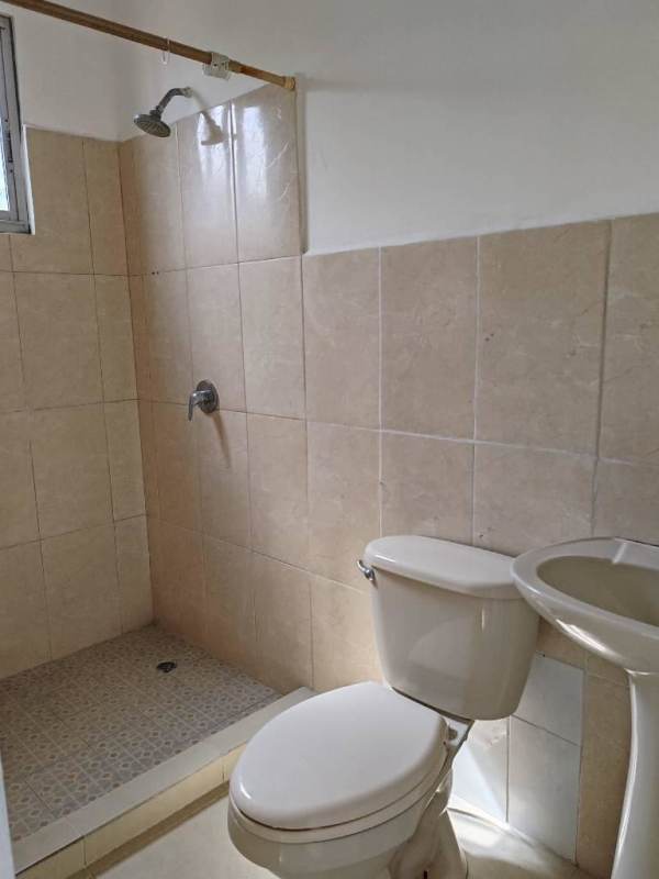 Compact laundry with granite countertop next to kitchen in PH El Ingenio Residences Panama